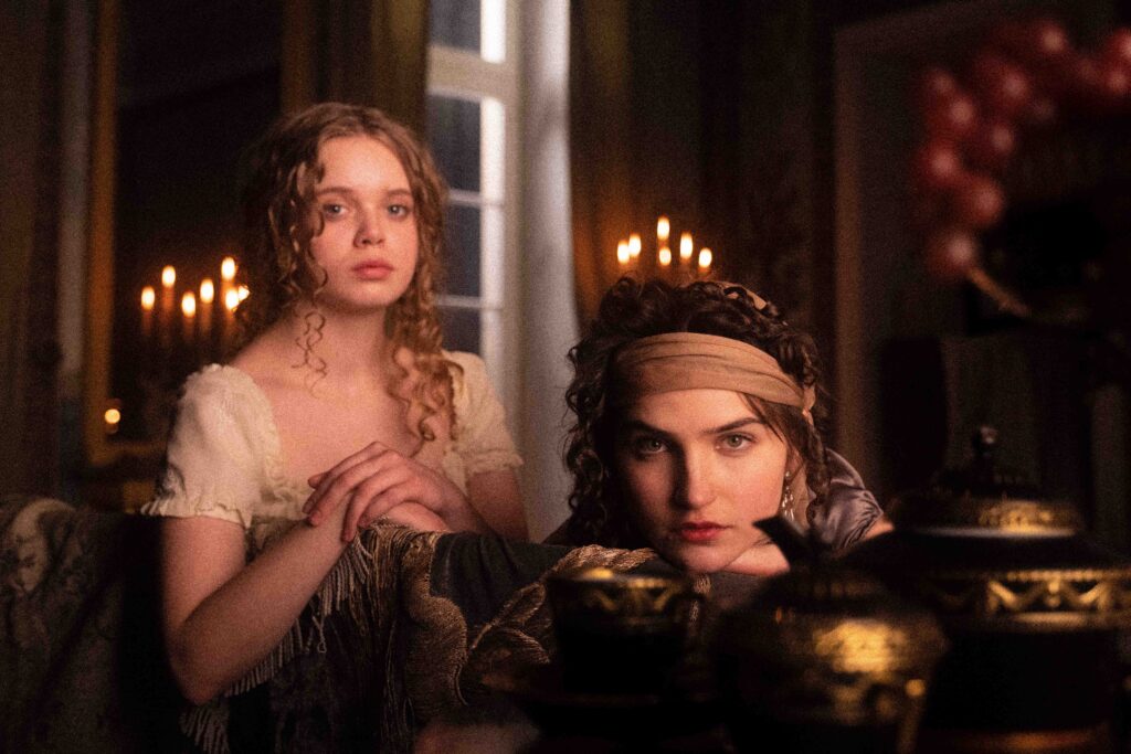 BTS from short film 'Titaninnen' (2023) – Friederike and Luise of Mecklenburg-Strelitz in a candlelit interior, neoclassical KPM porcelain, fine silk fabrics, historical portrait