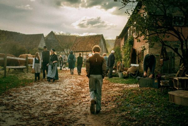 Revived (2018) – Set Design for commercial short film, rural village street in the 1930s with townspeople, timber houses and a boy walking along muddy path, dramatic sky