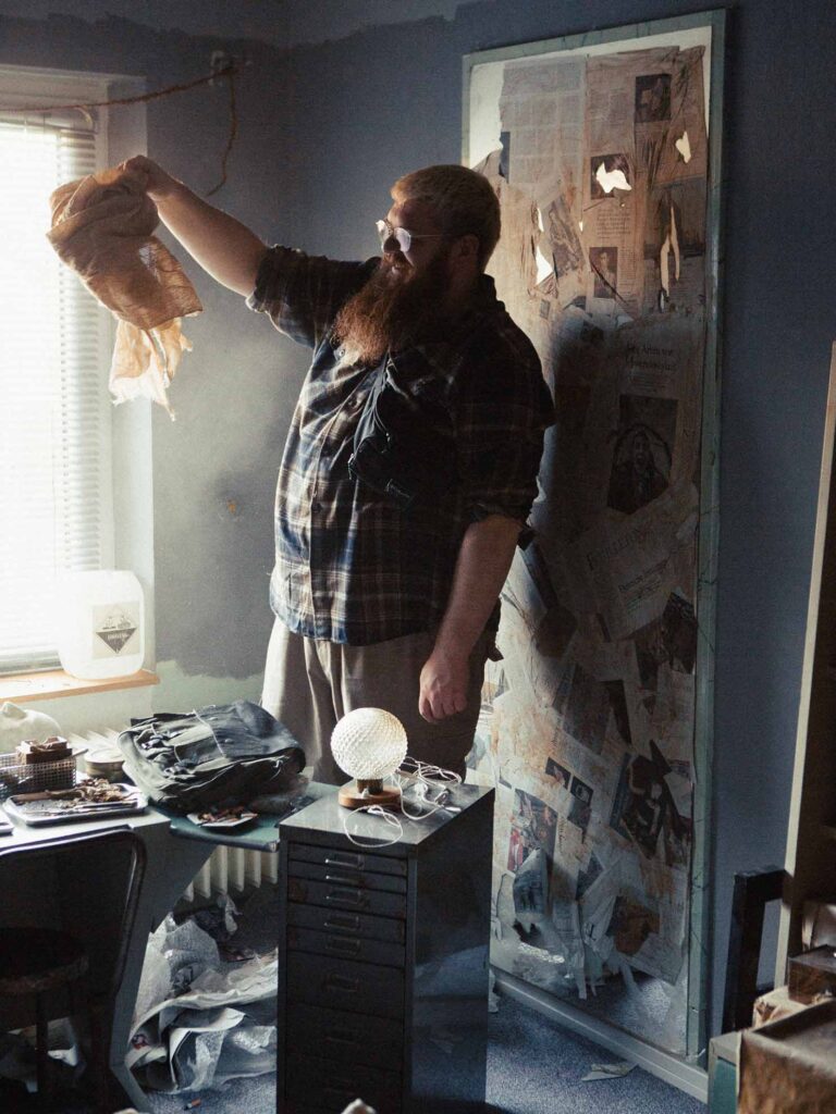Picobello (2026) – Dismantling the Set with Production Designer Jan Christoph Scheurer Picobello (2026) – Dismantling the Set with Production Designer Jan Christoph Scheurer, holding fabric in dusty light, candid and playful behind-the-scenes moment