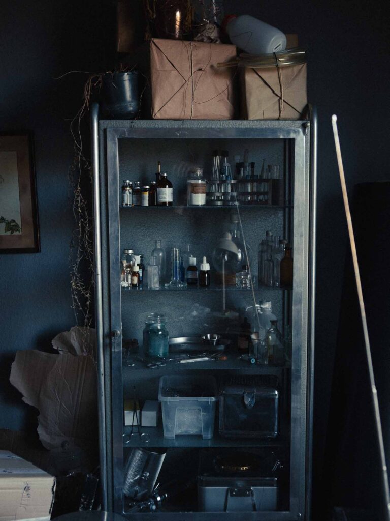 Picobello (2026) – Behind the Scenes Still - production design Picobello (2026) – Production Design for short film, metal locker with glass doors, sterile instruments and jars arranged in cool, clinical lighting